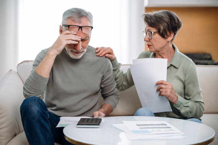 Stressed retired wife and husband manage family finances