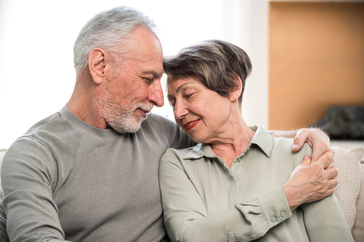 Portrait of mature couple hugging, spending happy weekend together